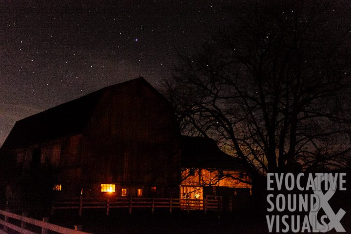 Light from dangling kerosene lamps illuminates Milo Yoder's barn as he and his family begin their chores before sunrise on November 11, 2016. Photo by Richard Alan Hannon