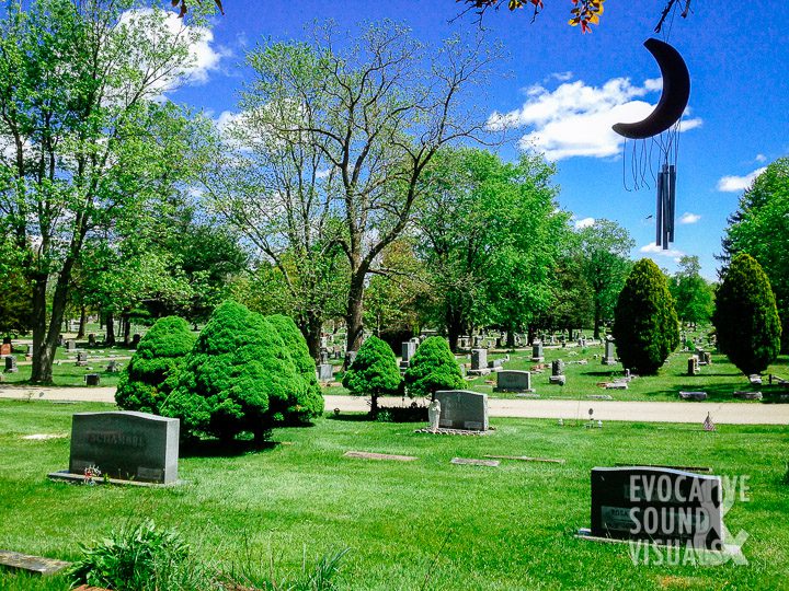 A weathered crescent moon wind chime hangs from a tree at a cemetery in north-central Ohio on May 7, 2017. Photo by Richard Alan Hannon