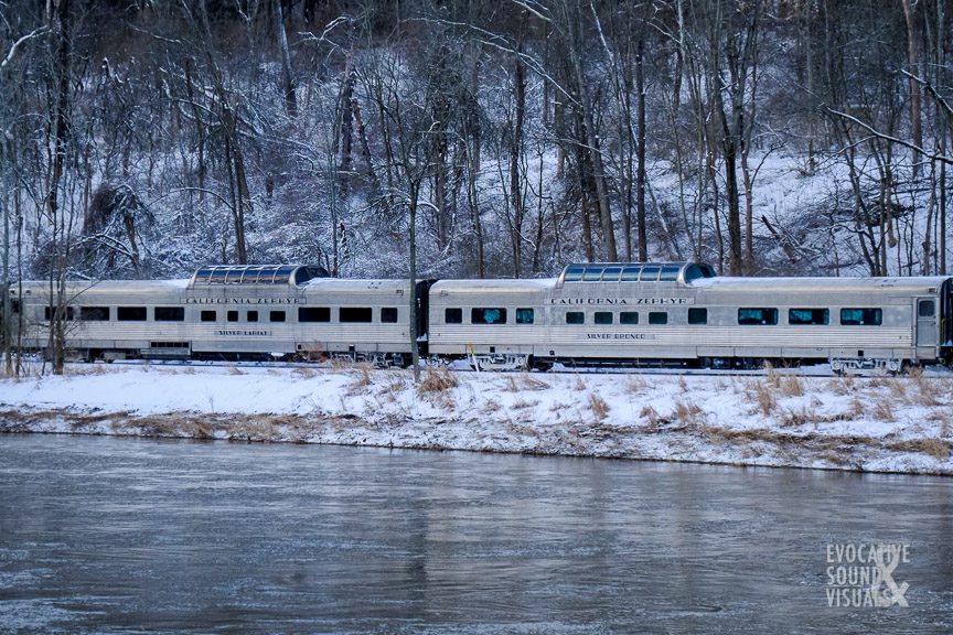 Vintage passenger cars are part of an excursion train traveling northbound on a cold winter morning along the Cuyahoga River past Canal Exploration Center in Valley View, Ohio on Saturday, February 19, 2022. Photo by Richard Alan Hannon