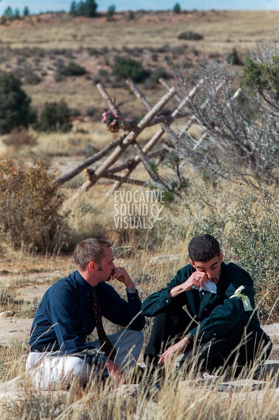 University of Wyoming student Clint Schroeder, left, and Graham Baxendale, visiting lecturer on hate crimes from Reading, England, find an opportunity during a lunch break to pause where Matthew Shepard was tied to a buck-and-rail fence a mile northeast of Laramie. Photo by Richard Alan Hannon