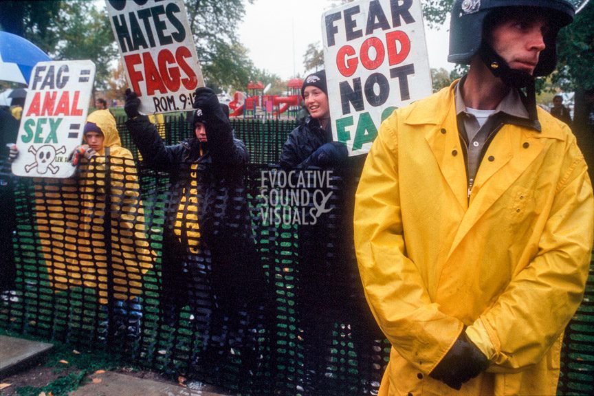 Police stand in a no man's land between friends and supporters of slain gay University of Wyoming student Matthew Shepard and members of Fred Phelps' Westboro Baptist Church of Topeka, Kansas, during Shepard's funeral in Casper, Wyoming on Friday, October 16, 1998. Photo by Richard Alan Hannon