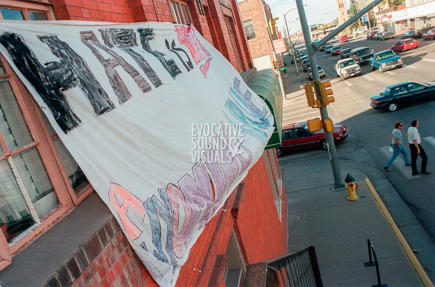A banner with the words, 'Hate is not a Wyoming Value,' hangs above the main street in downtown Laramie, Wyoming. Photo by Richard Alan Hannon
