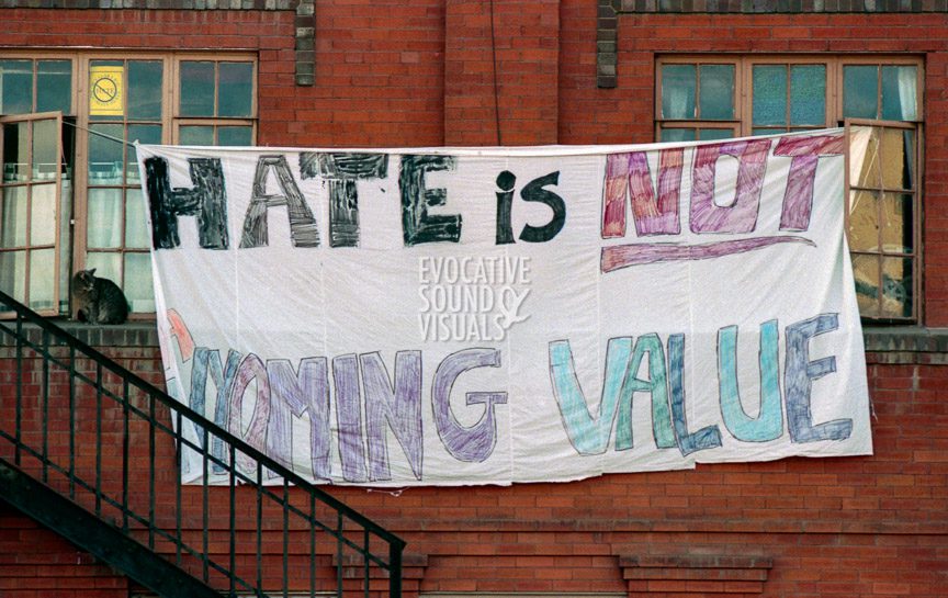 A banner with the words, 'Hate is not a Wyoming Value,' hangs in downtown Laramie, Wyoming. Photo by Richard Alan Hannon
