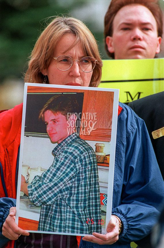 Cathy Connolly, an associate professor of sociology at the University of Wyoming, holds a photograph of Matthew Shepard as she attends a press conference outside the Albany County Courthouse on Tuesday, October 13, 1998. Photo by Richard Alan Hannon