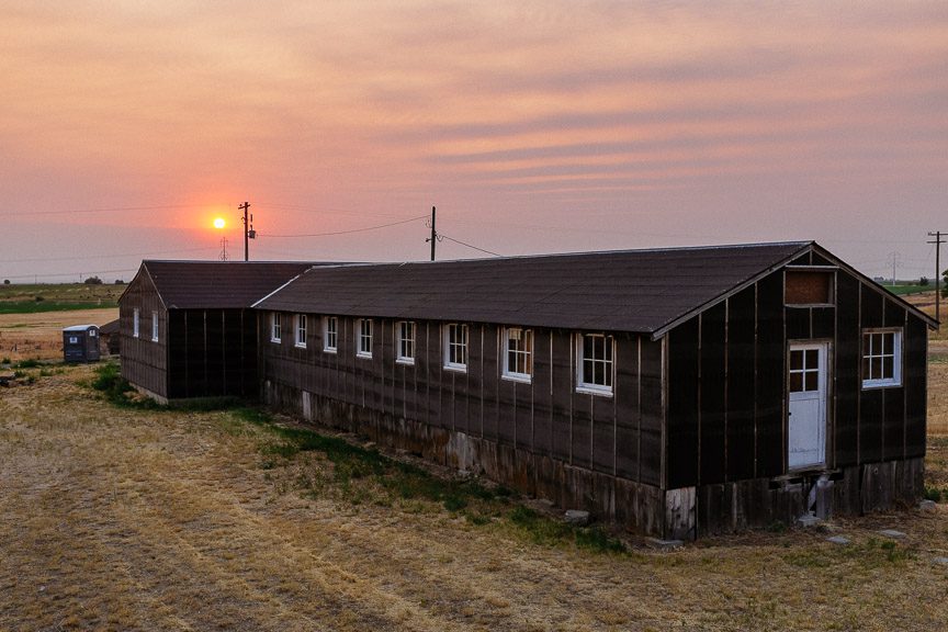 The sun rises above Fire Station #1 at Minidoka National Historic Site on Saturday, July 28, 2018, in Hunt, Idaho. Between August 1942 and October 1945, nearly 9,500 Japanese Americans from Portland, Oregon, Seattle and the surrounding areas were interned at Minidoka. When the National Park Service established the Minidoka National Historic Site in 2001, it included only a fraction of the original 950-acre core of the camp. In 2011, The Conservation Fund protected nearly 140 more acres: the former site of the internment camp’s fire station, water tower, military police headquarters, barracks blocks 21 and 22 and portions of adjacent blocks. Photo by Richard Alan Hannon