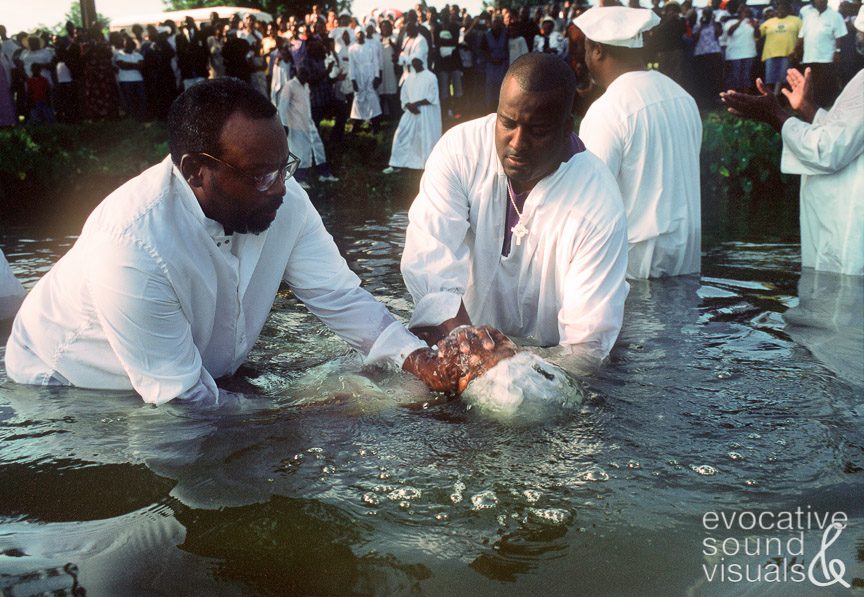 Rev. Emmanuel Jones, left, and Evangelist Darrin Dixon submerge a convent in the waters of Lake Providence on Sunday, August 1, 2004. The dunking takes no more than a second. Photo by Richard Alan Hannon