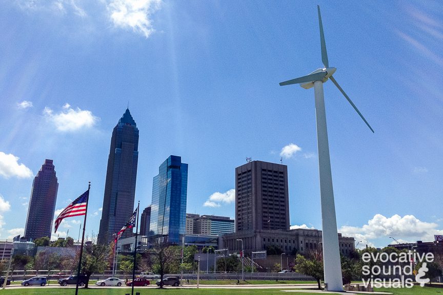 Richard Alan Hannon using contact microphones to record the Vestas V27 wind turbine as its 89-foot-diameter rotors cast a spinning shadow in front of the Great Lakes Science Center in Cleveland, Ohio August 18, 2016. Installed in 2006, the 146-foot tall turbine, capable of generating 225 kW of electricity (enough to power over 300 refrigerators) when wind speeds reach 31-mile per hour, needs a minimum 8-m.p.h. breeze to generate electricity, according to signage posted at the museum.