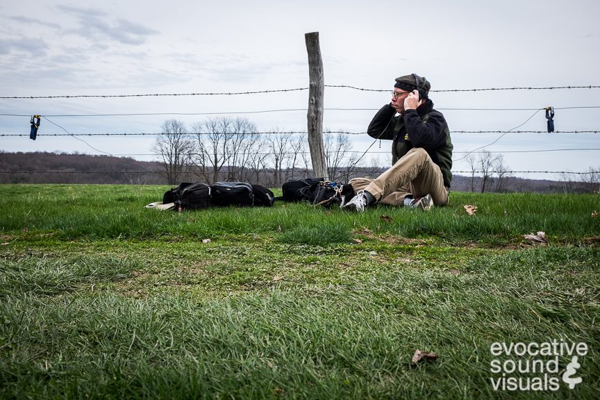Sound recordist Richard Alan Hannon capturing the sound of a wire fence with a pair of Barcus Berry contact microphones in Mansfield, Ohio on March 30, 2016. Photo by Richard Alan Hannon.