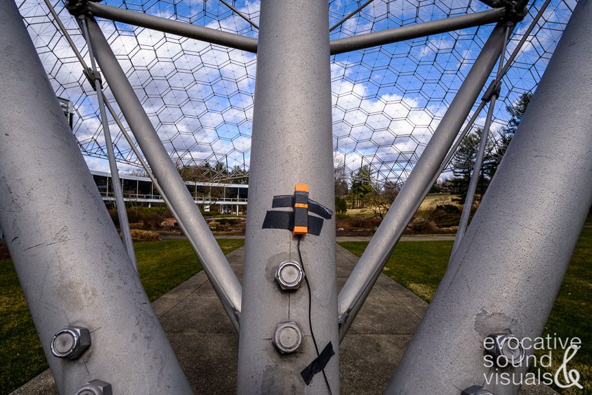 Using two contact microphones, one per pylon, to capture the sound of steady winds blowing across the open latticework geodesic dome that spans ASM International’s headquarters at Materials Park in Novelty, Ohio on Wednesday, February 15, 2023. The dome, built with extruded aluminum pipe in 1958 with over 65,000 parts, is the world’s largest open-work geodesic dome. It stands 103 feet high, measures 250 feet in diameter and weighs 80 tons. Photo by Richard Alan Hannon