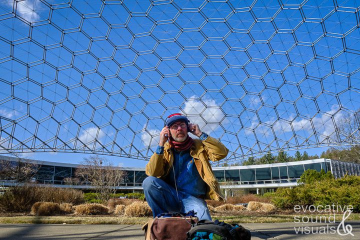 Field recordist Richard Alan Hannon captures the sound of steady winds blowing across the open latticework geodesic dome that spans ASM International’s headquarters at Materials Park in Novelty, Ohio on Wednesday, February 15, 2023. The dome, built with extruded aluminum pipe in 1958 with over 65,000 parts, is the world’s largest open-work geodesic dome. It stands 103 feet high, measures 250 feet in diameter and weighs 80 tons. Photo by Richard Alan Hannon