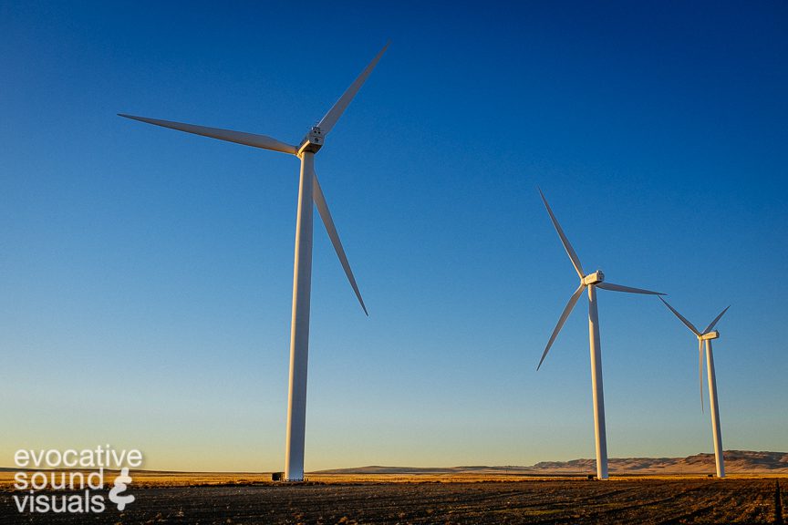 Three 404-foot (123.10 meter) tall S88 wind turbines, manufactured by Suzlon Energy and installed in 2009, face a setting sun in Glenns Ferry, Idaho on October 12, 2018. Part of the Mountain Home Wind Project, each turbine, with a rotor diameter of 88 metes, can produce 2.1 MW of electricity. Photo by Richard Alan Hannon