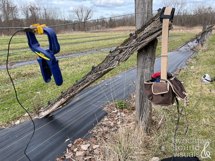 Capturing the sound of wind hitting a wire fence with a pair of contact microphones on a farm in Cuyahoga Valley National Park on Friday, March 8, 2024. Photo by Richard Alan Hannon